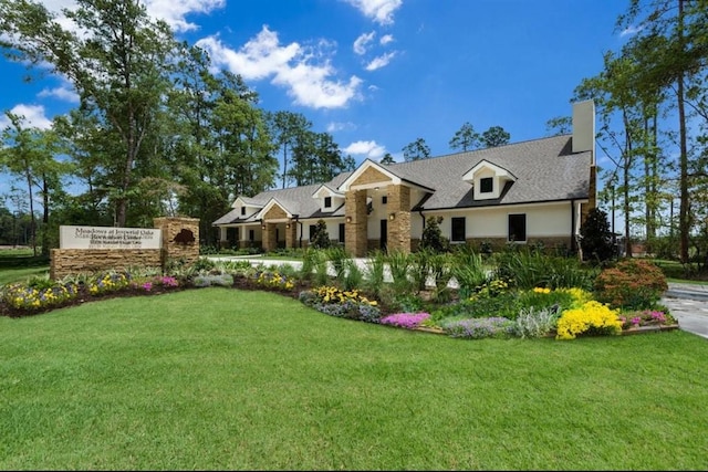 3306 Old Ironwood Dr, Spring, TX 77386 - view of front of house with stone siding, a chimney, and a front lawn