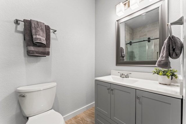 1314 W 4th St, Freeport, TX 77541 - bathroom with wood finished floors, vanity, toilet, baseboards, and a tile shower