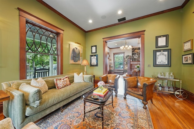 215 Bayland Ave, Houston, TX 77009 - living room with wood finished floors, ornamental molding, a chandelier, plenty of natural light, and recessed lighting