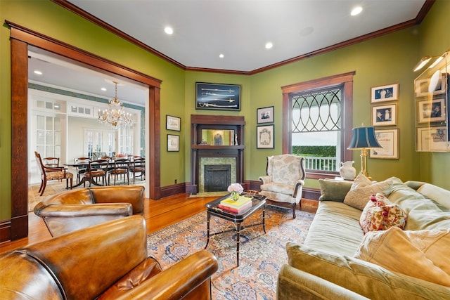 215 Bayland Ave, Houston, TX 77009 - living area with a chandelier, wood finished floors, ornamental molding, baseboards, and a fireplace with flush hearth