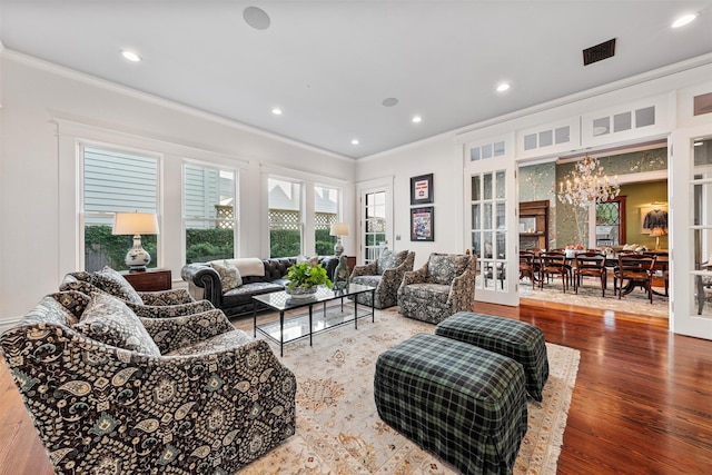 215 Bayland Ave, Houston, TX 77009 - living area featuring crown molding, a chandelier, french doors, wood finished floors, and recessed lighting