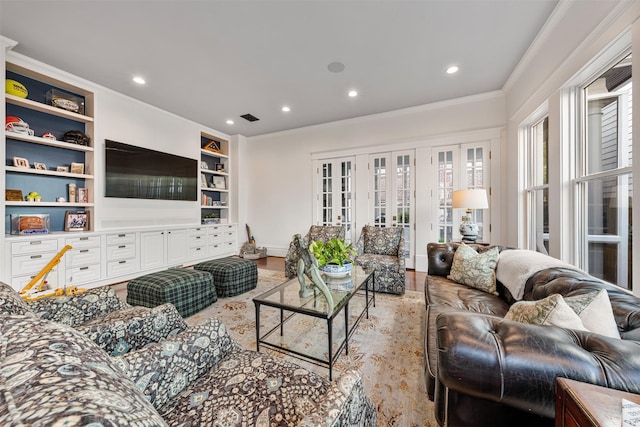 215 Bayland Ave, Houston, TX 77009 - living room with crown molding, recessed lighting, light wood-type flooring, built in shelves, and baseboards