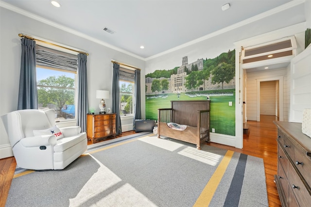 215 Bayland Ave, Houston, TX 77009 - living area featuring crown molding, wood finished floors, and recessed lighting