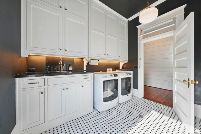 215 Bayland Ave, Houston, TX 77009 - laundry room with washing machine and clothes dryer, cabinet space, and baseboards