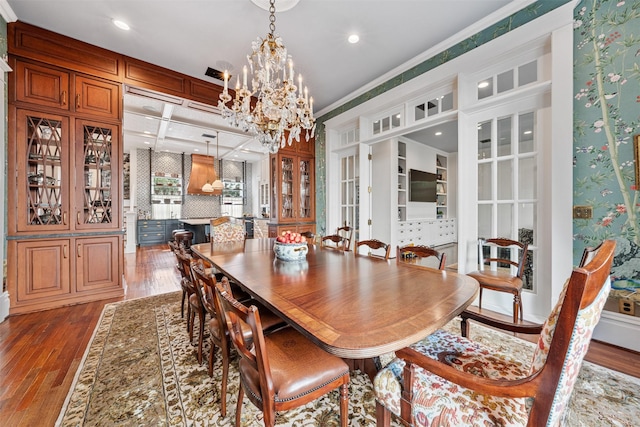 215 Bayland Ave, Houston, TX 77009 - dining area featuring wood finished floors, a chandelier, ornamental molding, wallpapered walls, and recessed lighting