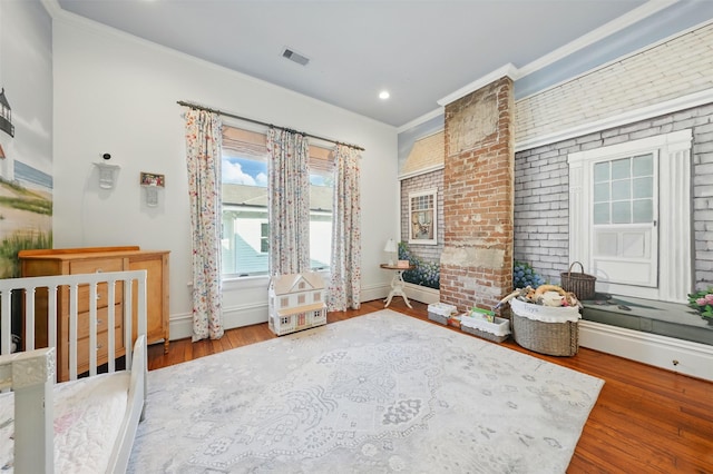 215 Bayland Ave, Houston, TX 77009 - bedroom with wood finished floors, crown molding, baseboards, and recessed lighting