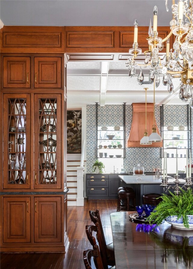 215 Bayland Ave, Houston, TX 77009 - kitchen featuring coffered ceiling, dark wood-type flooring, a chandelier, brown cabinets, and beamed ceiling