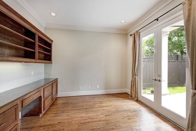 unfurnished dining area with french doors, light wood-style flooring, ornamental molding, baseboards, and recessed lighting