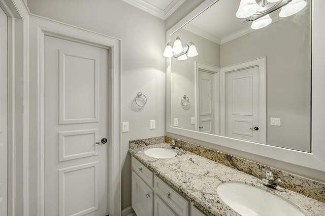 full bath featuring double vanity and crown molding