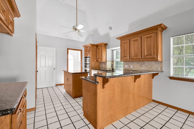 1803 Quiet Country Ct, Houston, TX 77345 - kitchen with ceiling fan, a center island, a sink, tasteful backsplash, and a peninsula