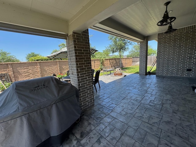 7010 Goldstrum Way, Katy, TX 77493 - fenced backyard featuring grilling area, a patio, and an outdoor fire pit