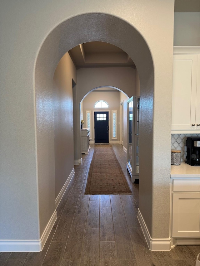 7010 Goldstrum Way, Katy, TX 77493 - corridor featuring dark wood-style floors, baseboards, and arched walkways