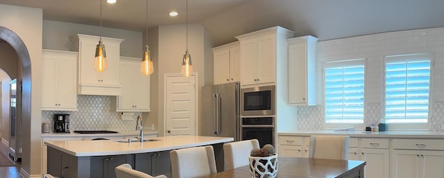 7010 Goldstrum Way, Katy, TX 77493 - kitchen featuring stainless steel appliances, a sink, a kitchen island with sink, tasteful backsplash, and white cabinets