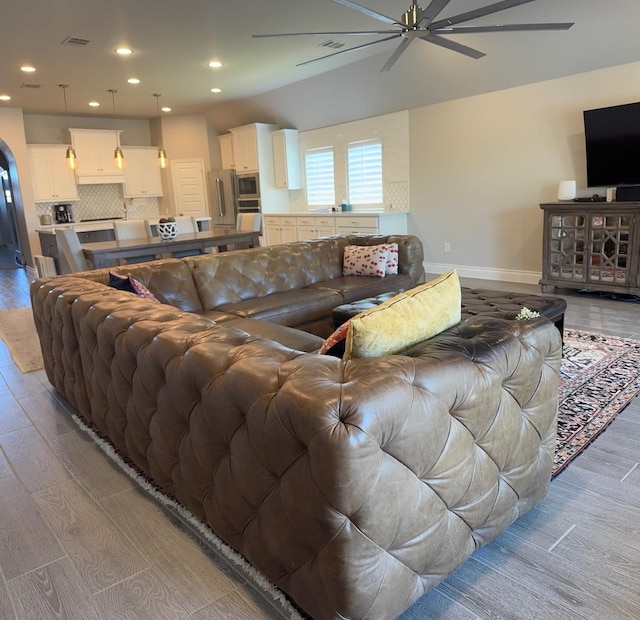 7010 Goldstrum Way, Katy, TX 77493 - living room with a ceiling fan, light wood-style flooring, baseboards, recessed lighting, and arched walkways