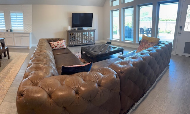 7010 Goldstrum Way, Katy, TX 77493 - living area with healthy amount of natural light, light wood-style floors, lofted ceiling, and baseboards