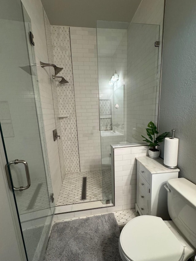 7010 Goldstrum Way, Katy, TX 77493 - bathroom featuring toilet, a shower stall, and a textured wall
