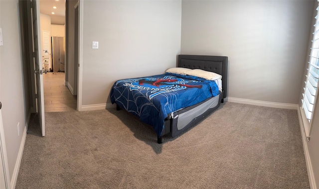 bedroom with carpet flooring and baseboards