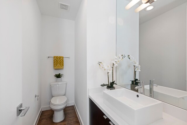 910 W 19th St Unit A, Houston, TX 77008 - bathroom featuring toilet, wood finished floors, vanity, and baseboards