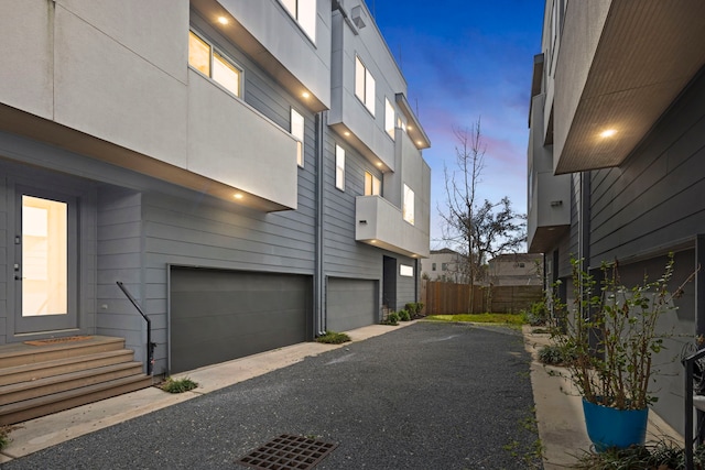 910 W 19th St Unit A, Houston, TX 77008 - view of property exterior featuring an attached garage and asphalt driveway