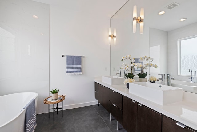 910 W 19th St Unit A, Houston, TX 77008 - full bath with double vanity, tile patterned flooring, a freestanding tub, baseboards, and recessed lighting