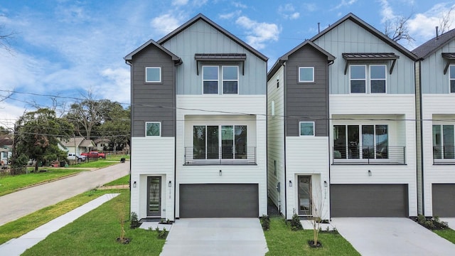 1218 English St, Houston, TX 77009 - view of front of house featuring board and batten siding, an attached garage, and concrete driveway