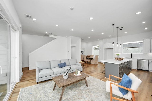 1218 English St, Houston, TX 77009 - living area featuring light wood-style flooring, recessed lighting, and stairs