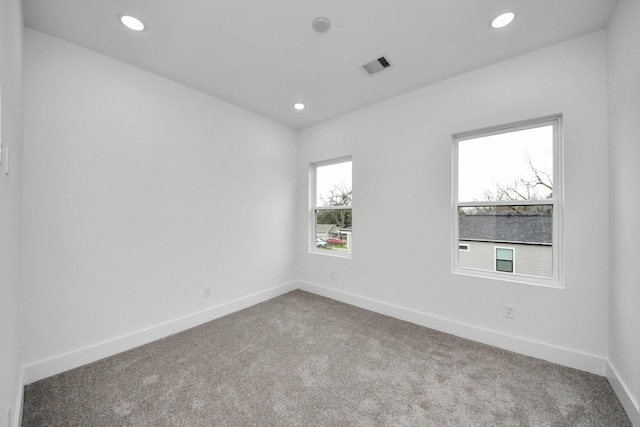 1218 English St, Houston, TX 77009 - empty room featuring carpet, baseboards, and recessed lighting