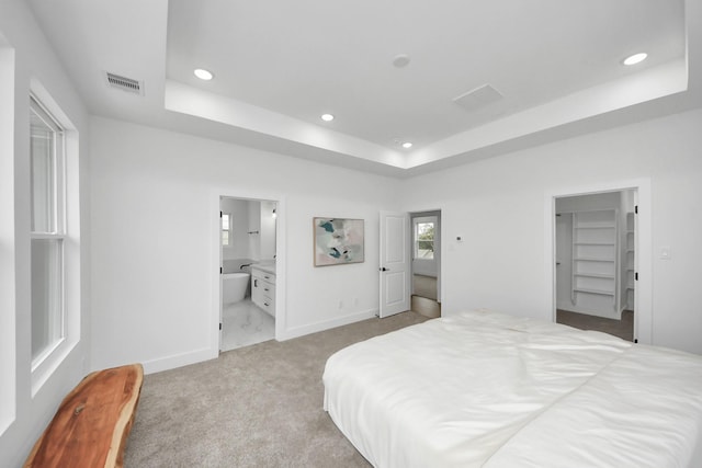 1218 English St, Houston, TX 77009 - bedroom featuring a tray ceiling, recessed lighting, carpet, baseboards, and a walk in closet