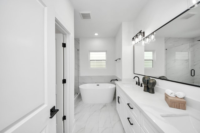 1218 English St, Houston, TX 77009 - full bathroom with marble look tiles, a marble finish shower, a freestanding bath, double vanity, and recessed lighting