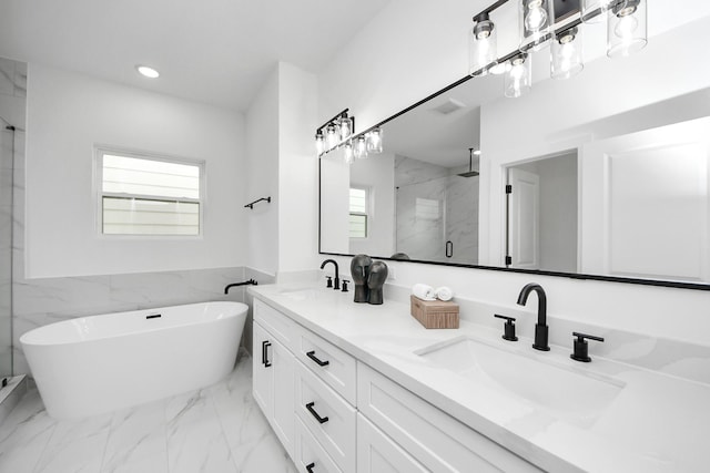 1218 English St, Houston, TX 77009 - bathroom with a marble finish shower, plenty of natural light, a soaking tub, recessed lighting, and double vanity