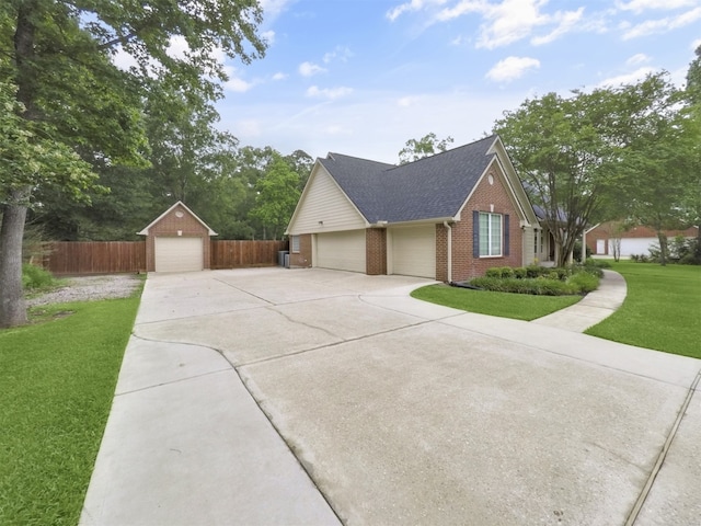 11987 White Oak Xing, Conroe, TX 77385 - view of front facade with brick siding, concrete driveway, and a shingled roof