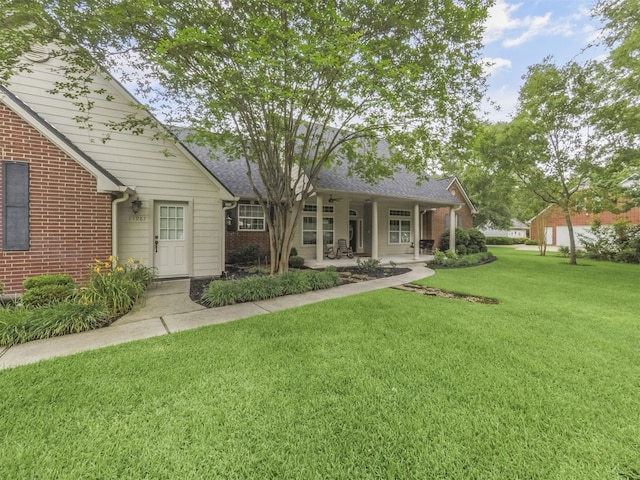 11987 White Oak Xing, Conroe, TX 77385 - back of house featuring brick siding and a yard