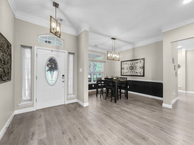 11987 White Oak Xing, Conroe, TX 77385 - foyer entrance featuring a chandelier, crown molding, wood finished floors, and baseboards
