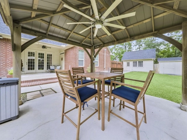 11987 White Oak Xing, Conroe, TX 77385 - view of patio featuring a ceiling fan, french doors, outdoor dining space, and an outdoor structure