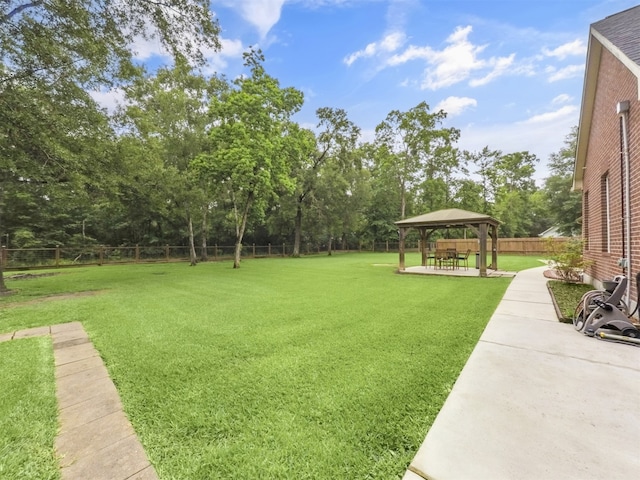 11987 White Oak Xing, Conroe, TX 77385 - view of yard featuring a gazebo, view of wooded area, and a patio area