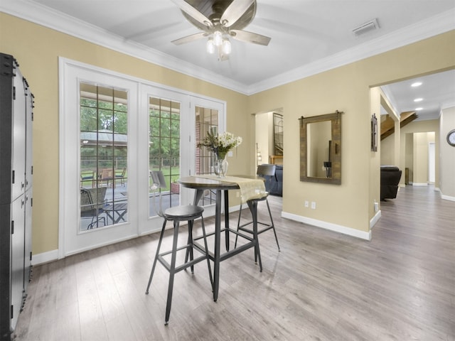 11987 White Oak Xing, Conroe, TX 77385 - dining room featuring crown molding, a ceiling fan, baseboards, and wood finished floors