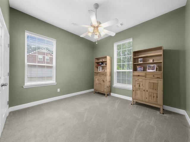 11987 White Oak Xing, Conroe, TX 77385 - unfurnished room with baseboards, carpet flooring, and ceiling fan