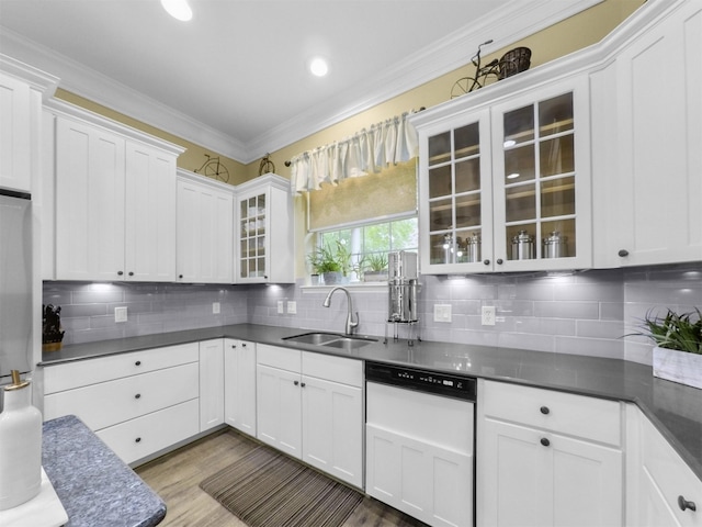 11987 White Oak Xing, Conroe, TX 77385 - kitchen featuring a sink, dishwashing machine, crown molding, glass insert cabinets, and dark countertops