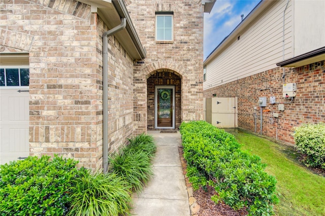view of exterior entry with brick siding