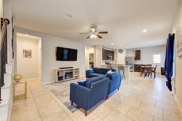 living room with a ceiling fan, light tile patterned floors, recessed lighting, and baseboards