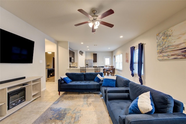 living room with light tile patterned flooring, ceiling fan, and recessed lighting
