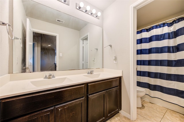 bathroom with tile patterned floors, toilet, double vanity, and curtained shower