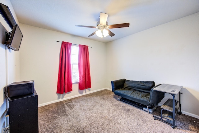living area with carpet flooring, ceiling fan, and baseboards