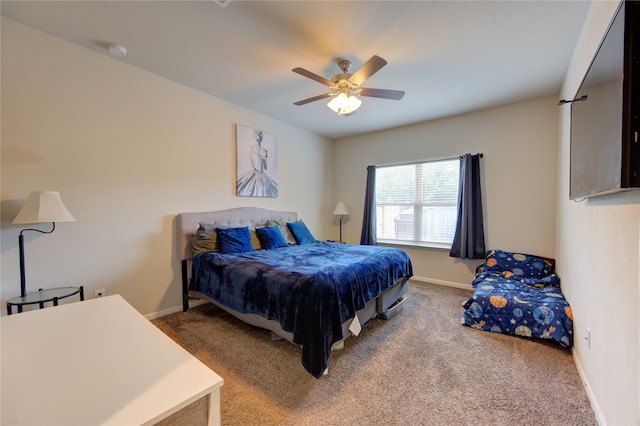 carpeted bedroom with baseboards and a ceiling fan