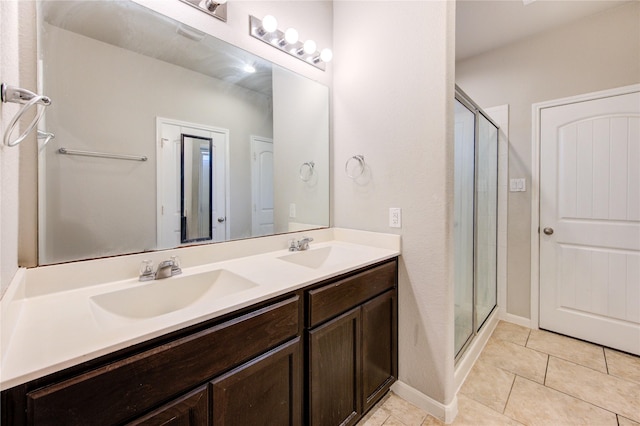 full bathroom featuring a stall shower, double vanity, and tile patterned floors