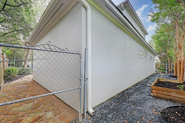 910 Peachwood Bend Dr, Houston, TX 77077 - view of home's exterior with fence, a gate, and stucco siding