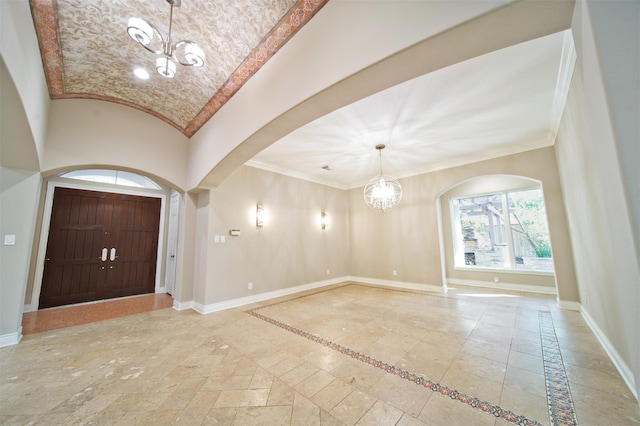910 Peachwood Bend Dr, Houston, TX 77077 - entrance foyer featuring a chandelier, arched walkways, inlaid floor details, baseboards, and stone tile flooring