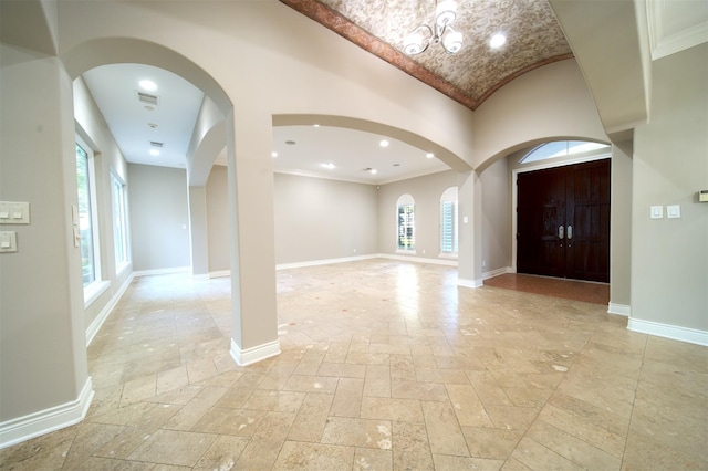 910 Peachwood Bend Dr, Houston, TX 77077 - foyer featuring stone tile flooring, healthy amount of natural light, baseboards, crown molding, and vaulted ceiling
