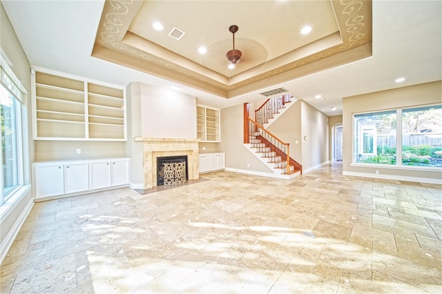 910 Peachwood Bend Dr, Houston, TX 77077 - unfurnished living room with built in shelves, healthy amount of natural light, stairway, baseboards, and recessed lighting