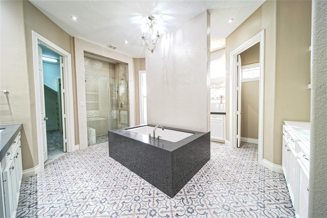 910 Peachwood Bend Dr, Houston, TX 77077 - full bath featuring a stall shower, a garden tub, vanity, a chandelier, and baseboards